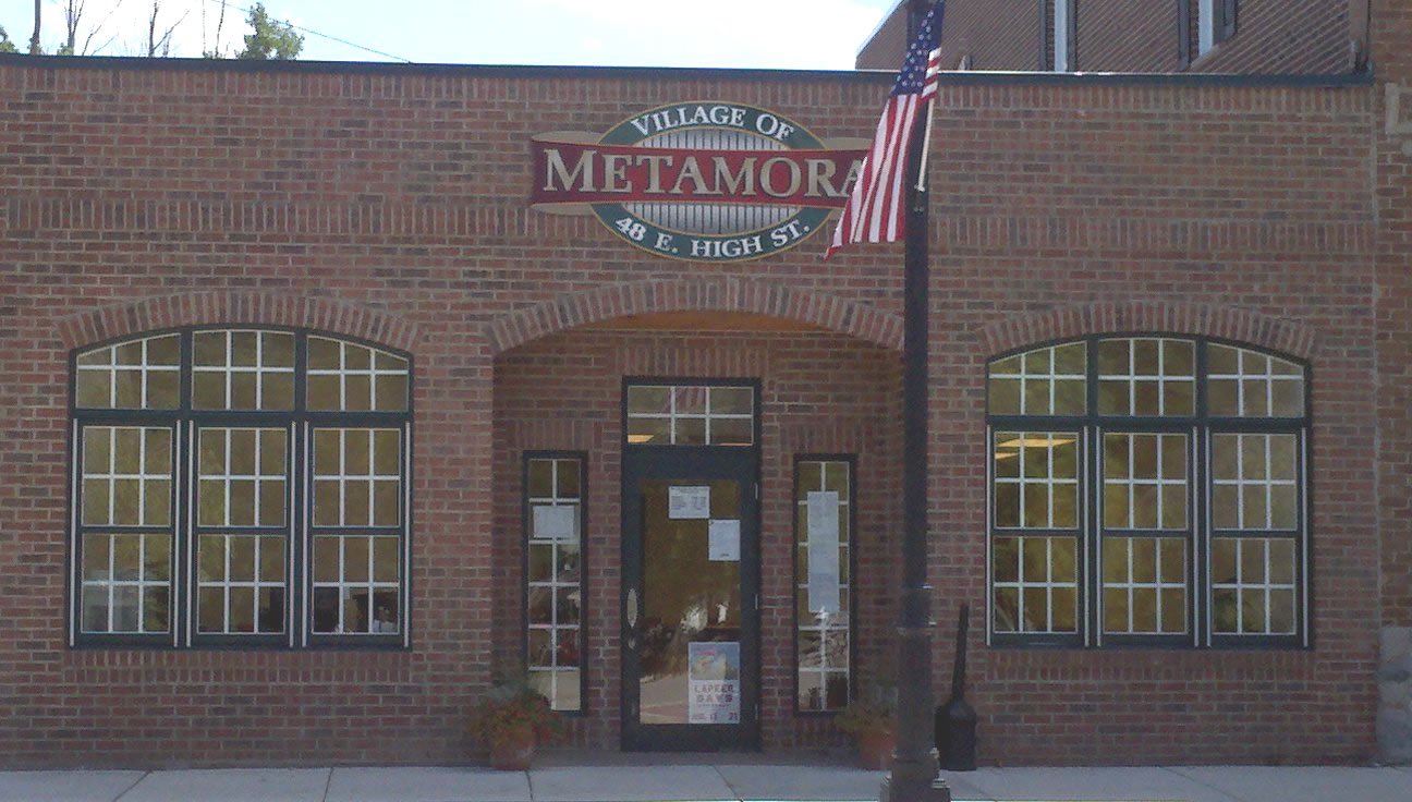 Metamora Village building entrance with American flag.