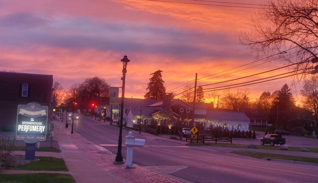 Vibrant sunset sky over a peaceful street.